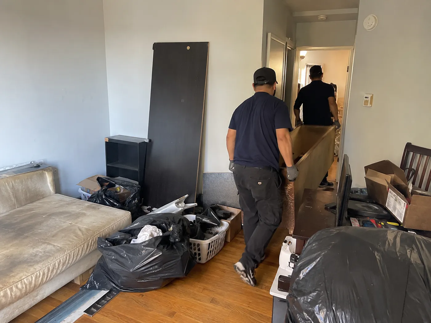 Junk removal crew clearing furniture from an Oakland apartment